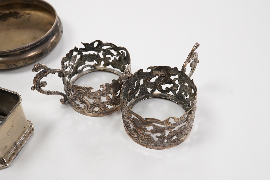 A collection of assorted silver to include five napkin rings including two pairs, a cased pair of glass butter dishes with silver butter knives, five golf related teaspoons, a cased set of six sterling cocktail sticks wi